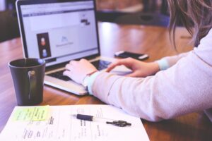 Person arbeitet mit Laptop am Schreibtisch